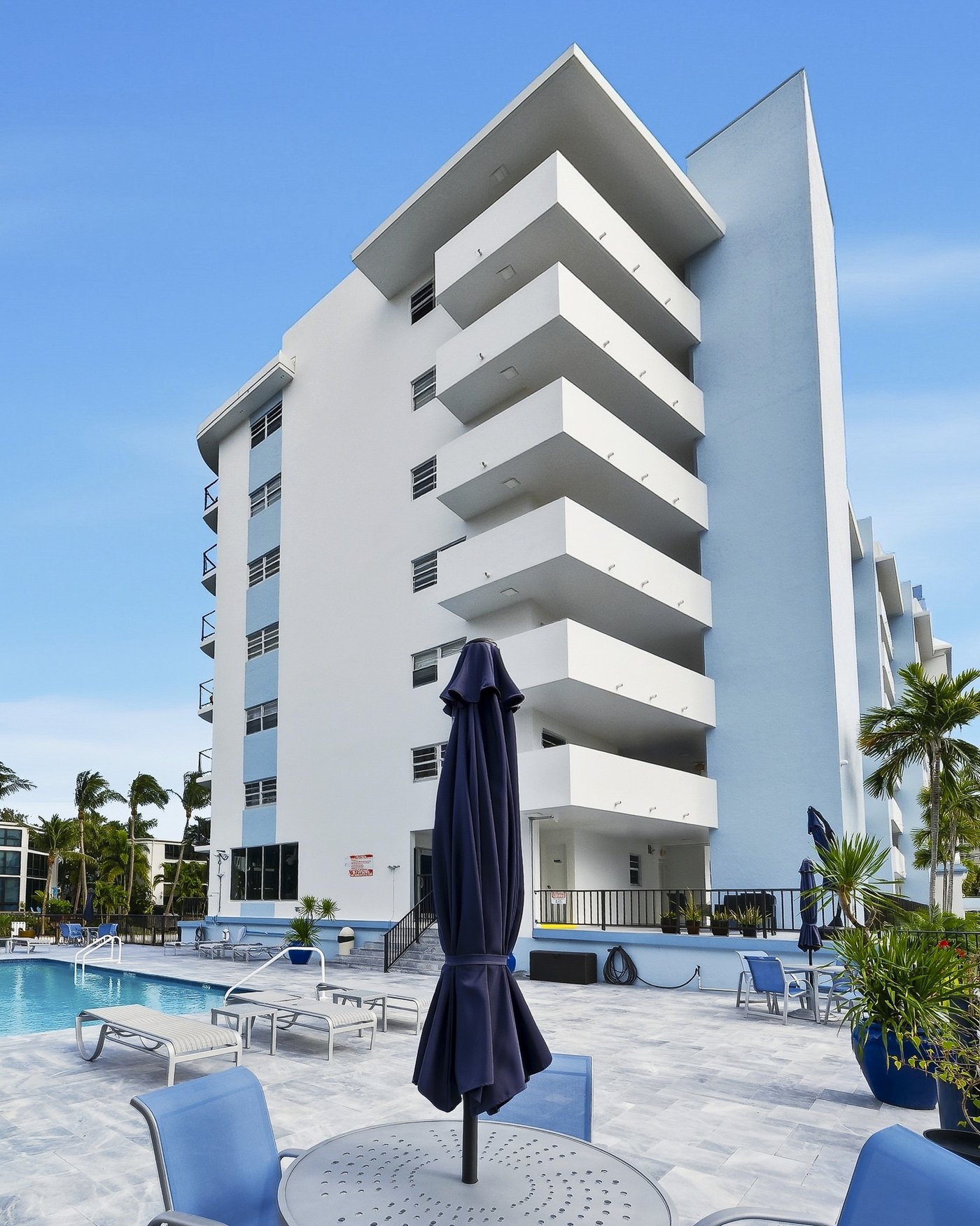 Ridgeview Towers from the pool deck — the building's cantilevered balconies and stepped profile against the Florida sky