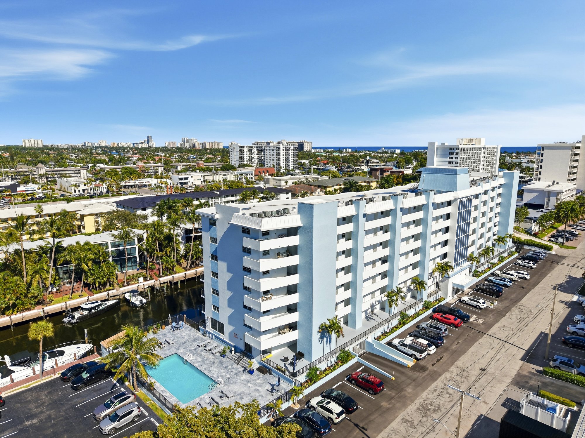 Ridgeview Towers viewed from the canal — full side profile showing all seven floors and the pool deck